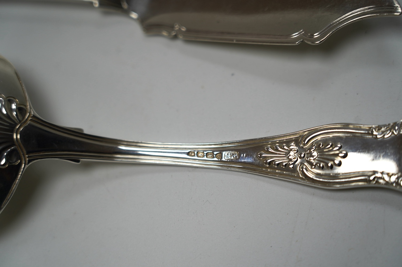 A pair of George IV silver King's pattern sauce ladles, by William Eaton, London, 1824, 17.5cm, two Victorian silver butter knives and a Victorian silver condiment spoon, 13.7cm, 10.5oz. Condition - fair to good